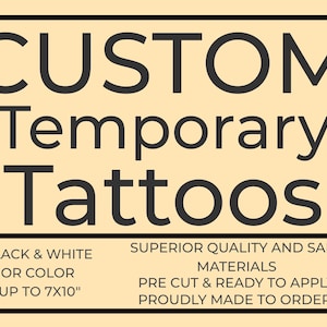 May include: A rectangular sign with the words "CUSTOM Temporary Tattoos" in large black letters. Below, smaller text reads "BLACK & WHITE OR COLOR UP TO 7X10" and other details about the product.