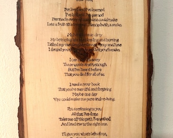 May include: A wooden sign with a poem titled "A Sinner's Prayer" written in a rustic style. The poem is a prayer to God, asking for forgiveness and guidance.