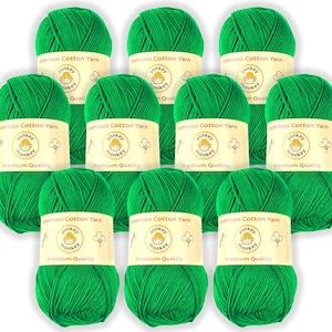 May include: A collection of ten bright green yarn skeins. Each skein has a label that reads "Bamboo Cotton Yarn" with a cartoon monkey logo. The yarn is tightly wound, suggesting it's ready for knitting or crochet projects.
