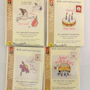 May include: Four cross-stitch kits for special occasions, each with a card and envelope. Designs include a stork with a baby, a birthday cake, a daisy, and a car with the text "Just Married!"