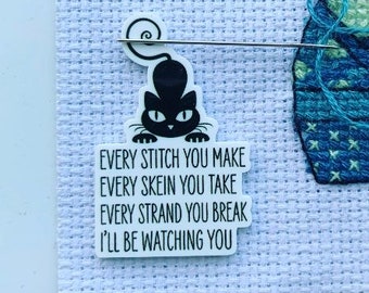 May include: A white sticker with a black cat illustration and the text "EVERY STITCH YOU MAKE EVERY SKEIN YOU TAKE EVERY STRAND YOU BREAK I'LL BE WATCHING YOU".