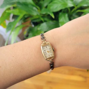 Vintage Elgin Art Deco Dainty Gold Womans Womens Classic Rectangular Cushion Stretch Watch. Approximately 5.8" around, stretchy.  tiny romantic style valentines valentine day gift present romantic vintage shape shaped styles tone gstret  U80