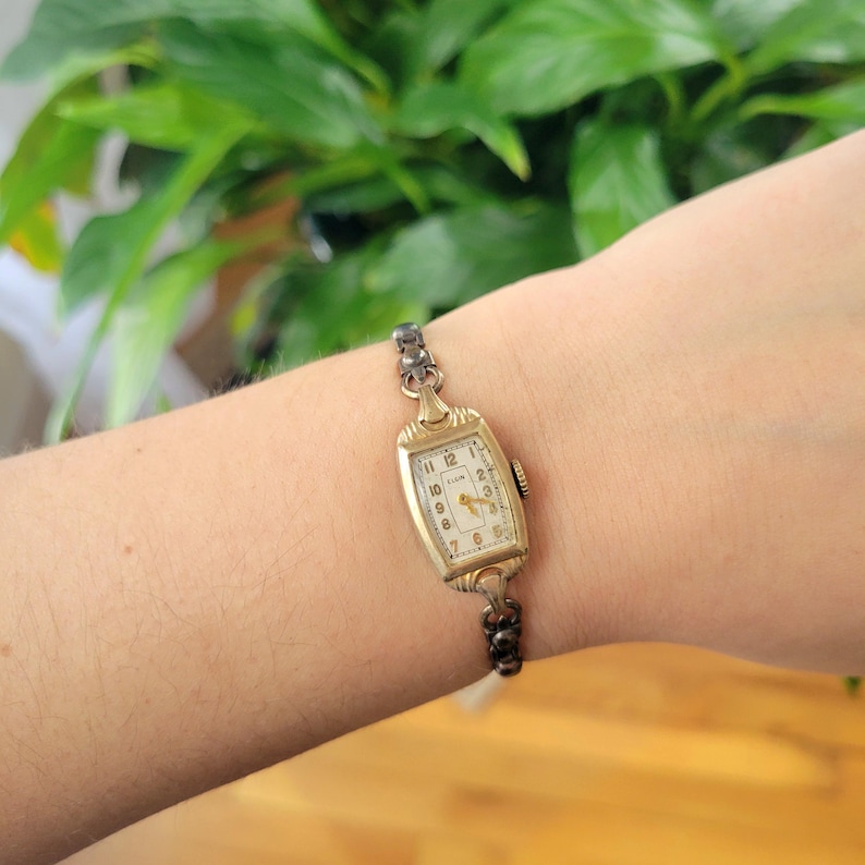 Vintage Elgin Art Deco Dainty Gold Womans Womens Classic Rectangular Cushion Stretch Watch. Approximately 5.8" around, stretchy.  tiny romantic style valentines valentine day gift present romantic vintage shape shaped styles tone gstret  U80