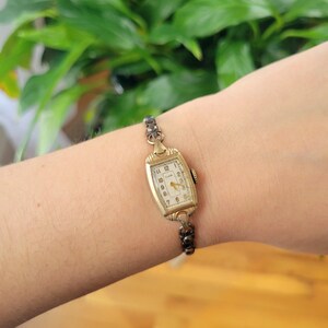 Vintage Elgin Art Deco Dainty Gold Womans Womens Classic Rectangular Cushion Stretch Watch. Approximately 5.8" around, stretchy.  tiny romantic style valentines valentine day gift present romantic vintage shape shaped styles tone gstret  U80