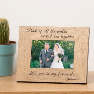 May include: A wooden picture frame with a photo of a bride and groom walking down the aisle. The frame has an engraved message that reads "Dad, of all the walks we've taken together... this one is my favourite. Gillian x".