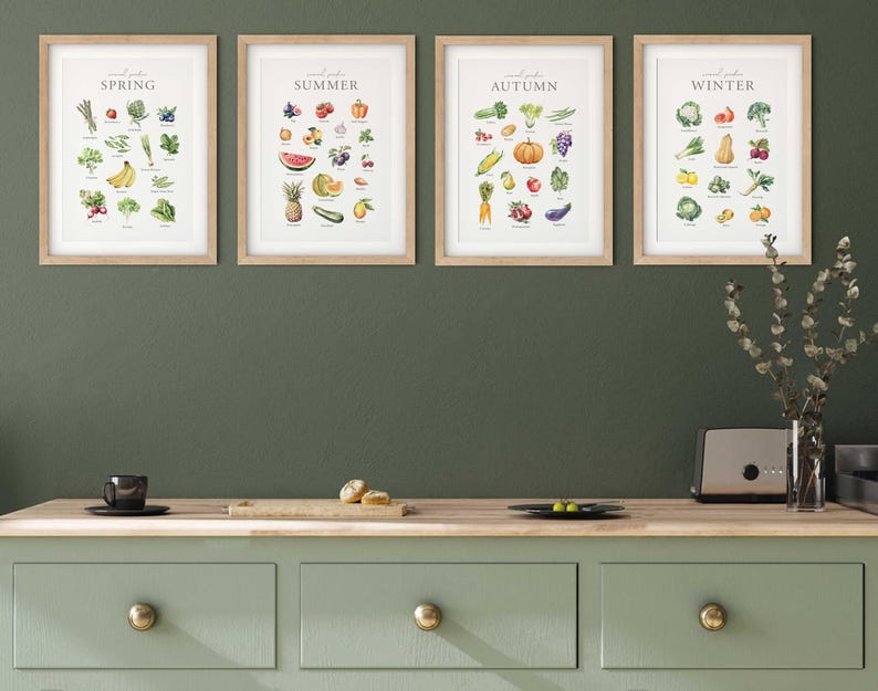 May include: Four framed prints on a green wall, each featuring a different season of the year with a list of fruits and vegetables. The prints are labeled "Spring", "Summer", "Autumn", and "Winter".