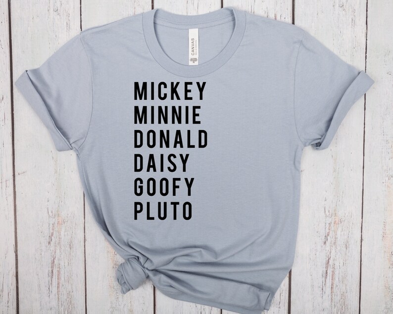 May include: A light blue t-shirt with black text that reads "Mickey Minnie Donald Daisy Goofy Pluto".