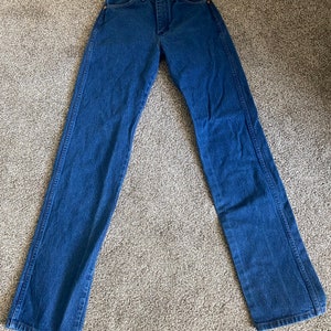 May include: A pair of blue denim jeans with a straight leg fit.