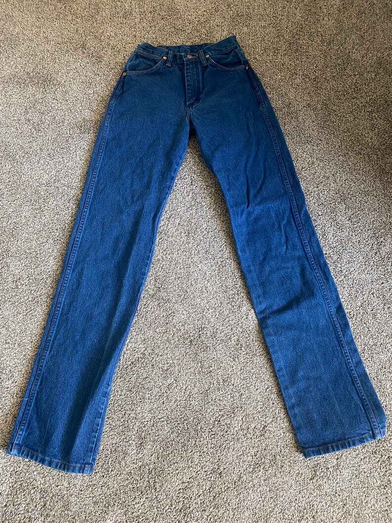 May include: A pair of blue denim jeans with a straight leg fit.