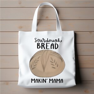 May include: White tote bag with a sourdough bread design. The bag has the text "Sourdough Bread Makin' Mama" printed on it.