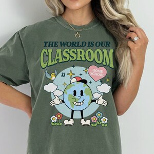 cute animated planet earth on a png file that reads the world is our classroom homeschool mom cute hearts and flowers groovy design