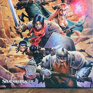 May include: A Dungeons & Dragons book cover featuring a group of fantasy characters in a dungeon setting. The characters include a warrior, a rogue, a wizard, and a cleric. The book title is "Shadowplague".