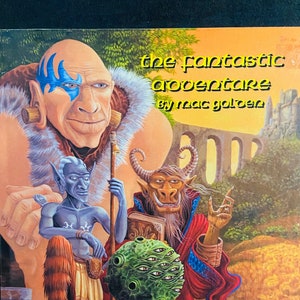 May include: A fantasy adventure module cover featuring a blue-skinned humanoid with a blue mark on its face, a green-skinned humanoid with horns and a red robe, and a green orb with multiple eyes. The text on the cover reads "The Fantastic Adventure by Mac Golden".