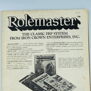 May include: A black and white advertisement for Rolemaster, a classic fantasy role-playing game system from Iron Crown Enterprises, Inc. The ad features a medieval castle illustration and text describing the different components of the game system, including the "Rolemaster" box, "Spell Law", "Arms Law & Class Law", "Character Law & Campaign Law", and "Loremaster".