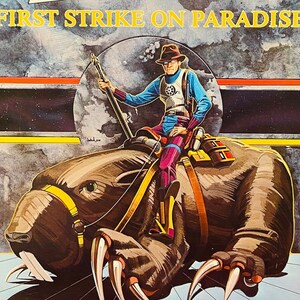 May include: A vintage paperback book titled "Starace: First Strike on Paradise." The cover features a science fiction illustration of a figure riding a large, clawed creature. The book has a blue border and the author's name is Jon Brunelle.