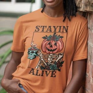Stayin&#39; Alive Skeleton Pumpkin Head Coffee Lover T-Shirt - Halloween Spooky Season Tee - Funny Coffee Drinkers Shirt - Gift for Coffee Fans