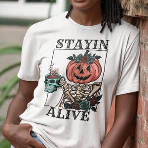 Stayin&#39; Alive Skeleton Pumpkin Head Coffee Lover T-Shirt - Halloween Spooky Season Tee - Funny Coffee Drinkers Shirt - Gift for Coffee Fans