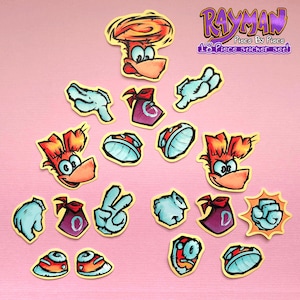 May include: A collection of 18 Rayman stickers, each with a yellow border, depicting characters and elements from the game. The stickers are arranged on a pink surface. The Rayman logo and 'Piece By Piece' text are visible.
