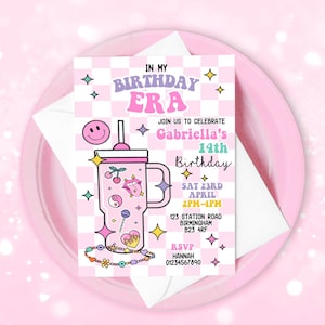 May include: A pink birthday invitation with the text "IN MY BIRTHDAY ERA" and "JOIN US TO CELEBRATE Gabriella's 14th Birthday". The invitation features a checkerboard pattern, a smiley face, and a cartoon drink with various graphics. The invitation is on a pink plate.