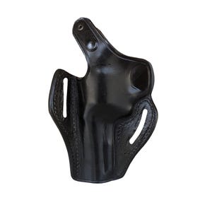 May include: A black leather holster with a glossy finish. The holster has a molded shape with stitched edges and several openings. A snap closure is visible at the top.