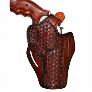 May include: A brown leather holster with a woven basket weave pattern. The holster is designed to hold a revolver, with a wooden handle visible. The leather is a rich, dark brown color.