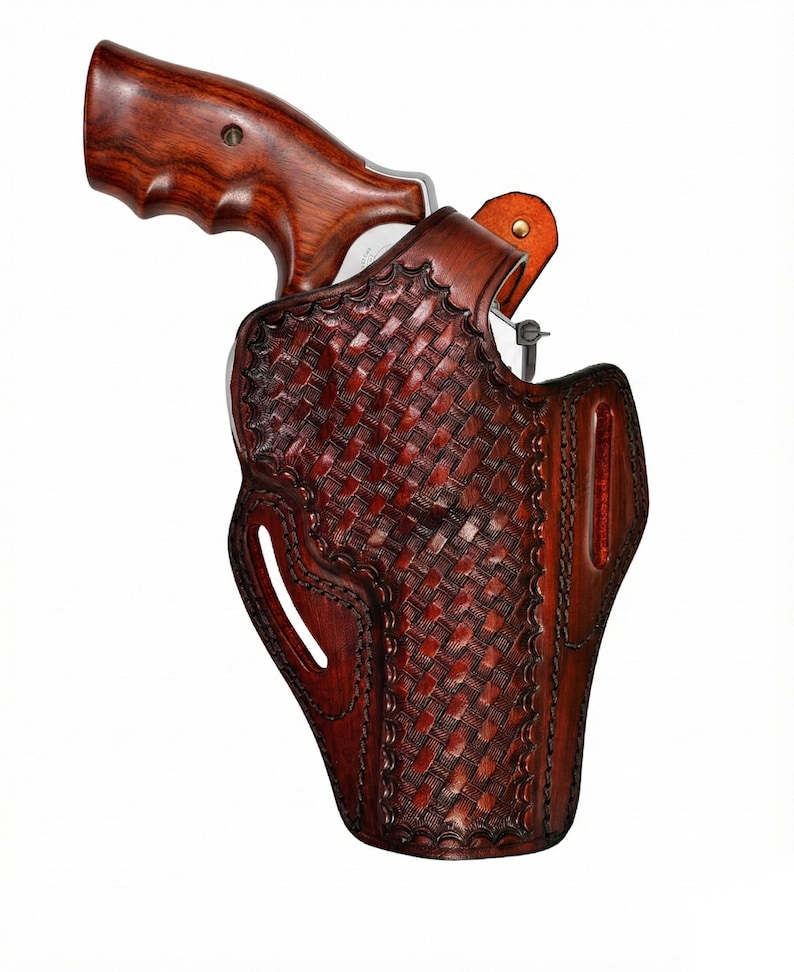 May include: A brown leather holster with a woven basket weave pattern. The holster is designed to hold a revolver, with a wooden handle visible. The leather is a rich, dark brown color.