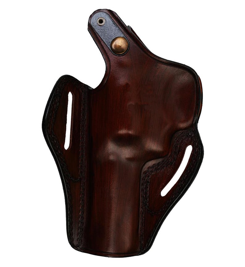 May include: A dark brown leather holster with a glossy finish. The holster features a curved design with stitched edges and two vertical slots. A metal rivet and a brass button secure the top flap.