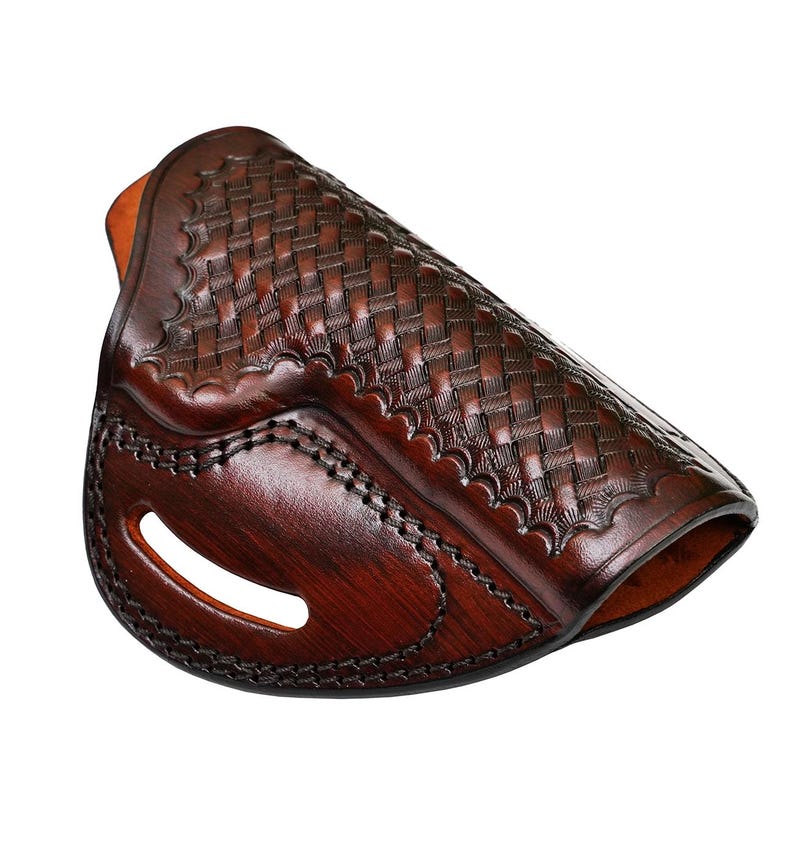 May include: A brown leather holster with a woven pattern. The holster has a stitched edge and a cut-out for a belt.