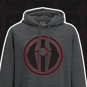 May include: A dark gray hooded sweatshirt with a red circle graphic on the front. The graphic features a black stylized symbol with a circle in the center.
