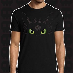 May include: Black t-shirt with a graphic print of a dragon's eyes. The eyes are green and the dragon is black.