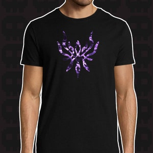 May include: A black t-shirt with a purple crest featuring a stylized design of a bird with outstretched wings.