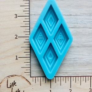 May include: A light blue silicone mold with four diamond-shaped cavities. Each cavity features a different geometric design.