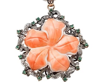 May include: A coral flower pendant necklace with a silver and gold filigree frame set with emerald and diamond accents.