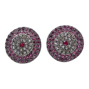 May include: A pair of silver earrings with a circular design. The earrings are set with small pink and white gemstones.