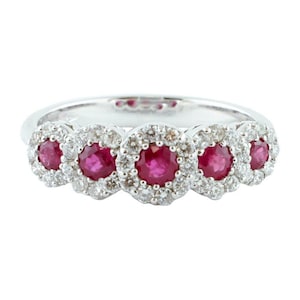 May include: A white gold ring with four ruby stones surrounded by a halo of diamonds.