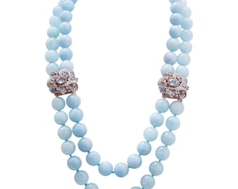 Collana in oro rosa 14 carati e argento con acquamarina, topazio e diamanti.