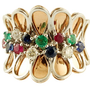 May include: A multi-gemstone ring featuring a floral design. The ring has a gold and silver-tone metal setting. The ring is adorned with a variety of gemstones, including diamonds, emeralds, rubies, and sapphires.