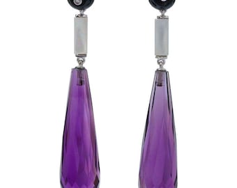 May include: A pair of dangle earrings with a teardrop-shaped amethyst gemstone, a white mother-of-pearl bar, and a black onyx bead with a small diamond accent.