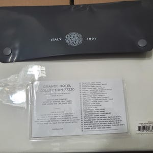 May include: A set of Grande Hotel Collection 77320 bed linens, packaged in a gray case with the word "ITALY" and the number "1891" printed on it. The set includes a sheet set and a list of available sizes.