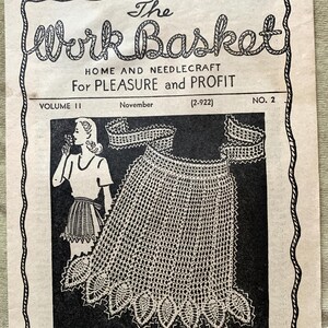 May include: A black and white illustration of a woman wearing a crocheted apron with a scalloped edge. The image is from a vintage magazine called "The Work Basket: Home and Needlecraft for Pleasure and Profit." The text reads "Ideas for the Bazaar, the Home, Gifts and Sparetime Money-makers - with Many Inexpensive, Easily Made Articles that find a Ready Sale."