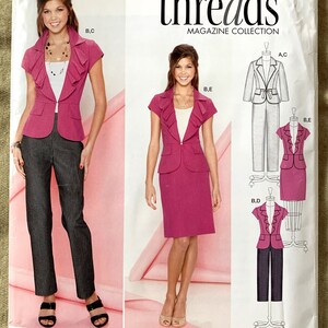 May include: A sewing pattern for a women's suit with a ruffled collar. The pattern includes three different views: a jacket and pants, a jacket and skirt, and a jacket only. The pattern is from Simplicity Threads Magazine Collection and is size 8-16.