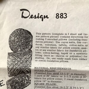 May include: A vintage sewing pattern, Design 883, featuring instructions for making three smocked pillows. The pattern includes material requirements for round, square, and bolster pillows, with finished sizes specified in inches. The image shows examples of the finished pillows.