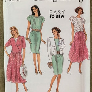 May include: Simplicity sewing pattern number 7164, size N5 (10-18), EUR. N5(38-46). The pattern includes instructions for making three different outfits: a green dress with a belt, a green skirt with a white jacket, and a pink skirt with a white top. The pattern is labeled "Easy to Sew."