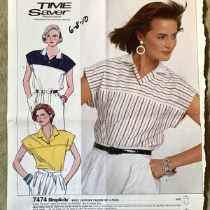 May include: A vintage Simplicity sewing pattern for a Misses' easy-to-sew pullover top. The pattern features illustrations of the top in different color combinations, including a striped design. The pattern number is 7474.