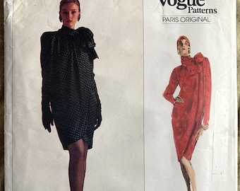 May include: Vogue Patterns Paris Original sewing pattern for a dress. The pattern is for an easy to sew dress and is labeled as pattern number 2210.