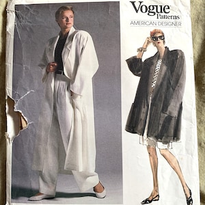 Puede incluir: Patrón de costura Vogue Patterns American Designer de Anne Klein. El patrón presenta dos diseños: una gabardina larga blanca y una gabardina negra con forro de lunares. El número de patrón es 1706.