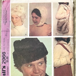 May include: Vintage McCall's 2966 sewing pattern featuring hats and bags. The pattern includes various hat styles, including a fur hat and a fur hood. The image also shows a shoulder bag. The pattern is for hats in two sizes.