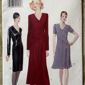 May include: Vogue Patterns sewing pattern featuring three dress designs. The cover shows illustrations of the dresses in black, burgundy, and gray. The pattern size is 6-8-10. The Vogue logo is at the top right.