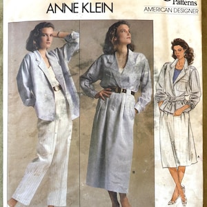 May include: Vogue Patterns sewing pattern featuring Anne Klein designs. The pattern includes images of a woman wearing a light blue blazer, dress, and pantsuit. The Vogue logo and "American Designer" text are visible. Pattern/Patron 1542.