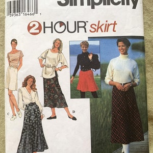 May include: Simplicity sewing pattern for a 2-hour skirt. The pattern cover features illustrations of various skirt styles, including a plaid skirt, floral skirt, and a solid-colored skirt. The pattern includes size options.